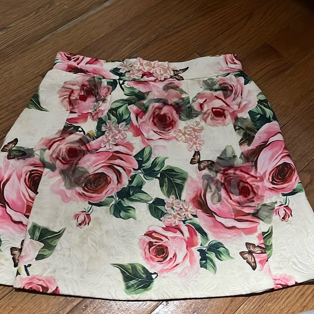 Has a stain that is barely visible, but such a beautiful mini skirt.